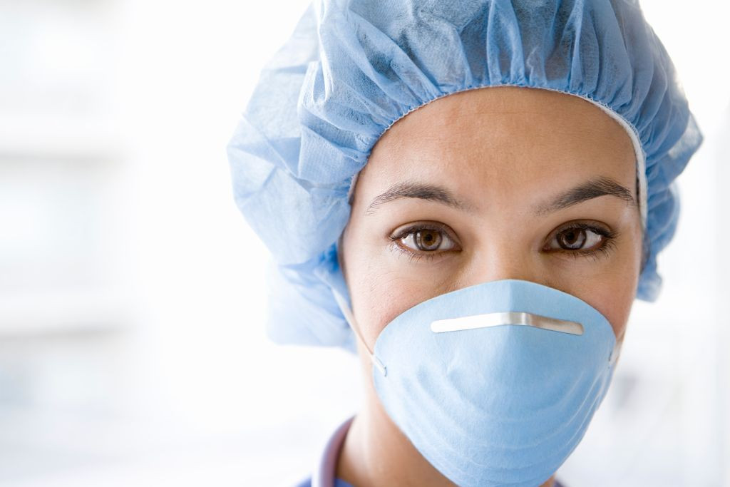 Junge Krankenschwester mit OP-Maske